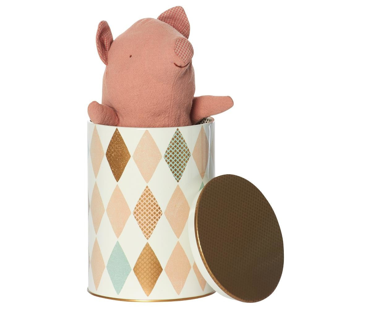 Soft pink pig truffle baby plush resting in colorful diamond-patterned tin with brown lid, einzigartig Wohndeko. - Pig Truffle Baby