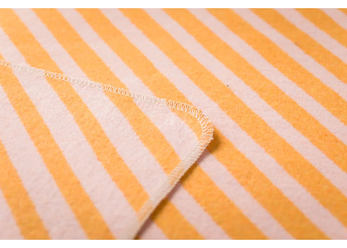 Soft cotton baby blanket with orange diagonal stripes, unique style and cozy charm for your home decor. - JUWEL Babydecke Diagonalstreifen orange