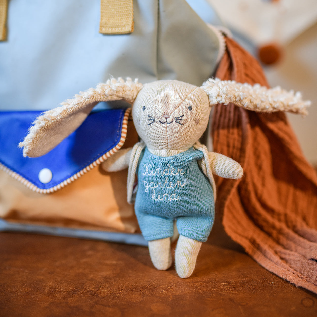 Small fabric bunny wearing blue overalls with "Kindergarten Hase" embroidery, unique home decor accent with individual style . - Hase Kindergartenkind mit Rucksack