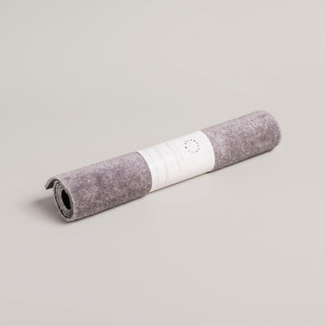 Rolled gray washable door mat with unique "Hereinspaziert" slogan, perfect for individual style and home decor favorites. - Waschbare Fußmatte Hereinspaziert